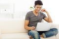 Man sitting in sofa and using laptop Royalty Free Stock Photo