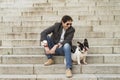 Man sitting on a stairs next to his dog Royalty Free Stock Photo