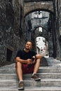 A man sitting on the steps. Use smartphone. Narni Terni, Umbria, Italy, medieval city: a typical old street Royalty Free Stock Photo