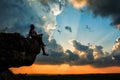 Man sitting on stone top of high mountain Royalty Free Stock Photo