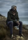 Man sitting on a stunning rugged coast