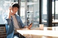 A man is sitting at a table with a cell phone in his hand Royalty Free Stock Photo