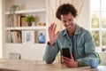 Man Sitting At Table At Home Using Mobile Phone For Video Call Royalty Free Stock Photo