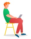 Man sitting on the tabouret and working with laptop in social networks holding computer on his knees