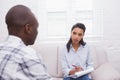 Man sitting with therapist taking notes Royalty Free Stock Photo