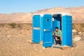 Man sitting in the Toilet in the middle of the desert - Death Va Royalty Free Stock Photo