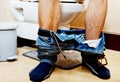 Man sitting on a toilet seat