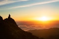 Man Sitting On Top Of Mountain Above Clouds Meditating Outdoors Royalty Free Stock Photo