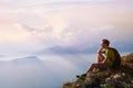 Man sitting on top of mountain, achievement or opportunity concept, hiker Royalty Free Stock Photo