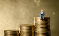 Man sitting on top of pile stack of golden coins