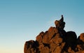 Man Sitting On Top Of Rock Cliff Meditating, Side View Royalty Free Stock Photo