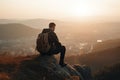 a man sitting on top of a rock overlooking a Royalty Free Stock Photo