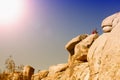 Man sitting on top of rocks in the desert Royalty Free Stock Photo