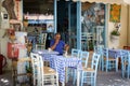 Man sitting at traditional Greek tavern at Paleochora town on Crete island