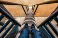 Man Sitting at Traditional Style Stairs with Wooden Handle Style at Radakng House Replica of a traditional Dayak tribal Royalty Free Stock Photo