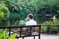 Man sitting in Tropical Location and Working