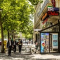 Man sitting in a typical bar with tabac shop and winter gardenn