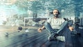 Man sitting underwater who relaxes in a yoga position