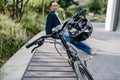 Man sitting in urban park with parked bicycle. Royalty Free Stock Photo