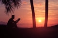 A man sitting and waiting to watching the sunrise on the coconut beach in the morning Royalty Free Stock Photo