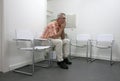Man sitting and waiting in waitingroom Royalty Free Stock Photo