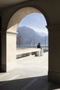 A man is sitting on the wall and he looks the lake from Lugano city Royalty Free Stock Photo