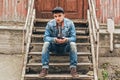 Man sitting on a wooden staircase. Old house Royalty Free Stock Photo