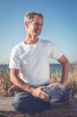 Man sitting in yoga pose.