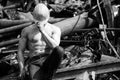 Man With Six Pack in Old Scrap Metal Garage Royalty Free Stock Photo