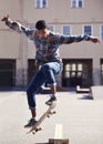 Man, skateboard and jump at urban skate park, sports and energy with skill, stunt and recreation activity outdoor Royalty Free Stock Photo