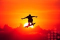 Man is skateboarding in the air over a sunset Royalty Free Stock Photo