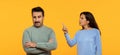 A man with a skeptical expression crosses his arms while a woman points a finger upwards Royalty Free Stock Photo