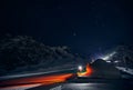 Man with ski near Yurt nomadic house at night at Mountains