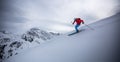 Man skiing in the deep snow of the Austrian alps with mountain peaks in the background Royalty Free Stock Photo