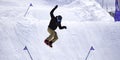 A man skiing and jumping on a slope of snow in a ski resort. Competitive skiing and jumping on a snow Royalty Free Stock Photo
