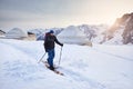Man skiing near yurt house snowy mountains Royalty Free Stock Photo