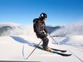 Man skiing on prepared slope with fresh snow. Snow gun machine making artificial snowfall. Magic nature on background. Royalty Free Stock Photo