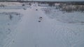 A man skiing with rope behind a car over snowy road, slow motion