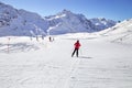 A man is skiing at a ski resort. Winter mountains, panorama - snow-capped peaks of the Italian Alps