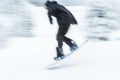 A man skiing snow board very fast. blurred picture. Royalty Free Stock Photo