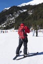 Man skiing in the snow in winter. Young man dressed in red black skiing gear. Skies at Bunderishka polyana, skiers on ski slopes,
