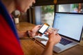 Man skilled trader using cellphone with empty mock up copy space screen and using credit card for purchase Royalty Free Stock Photo