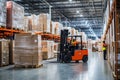 A man is skillfully driving a forklift inside a large warehouse Royalty Free Stock Photo