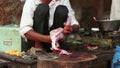 Man skinning chicken meat