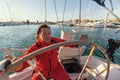Man skipper at the helm controls of a sailing yacht. Sport. Royalty Free Stock Photo