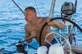 Man skipper steers the controls of a sailing yacht boat. Sport. Royalty Free Stock Photo