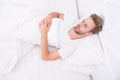 Man sleep in bed. early morning wakeup. man sleeping white bedroom. cosy weekend at home. time to relax. guy fall asleep Royalty Free Stock Photo