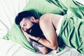 Man sleep on bed with very deep sleep. Man lying in bed and sleeping. Young man sleeping in bed with pillows at home Royalty Free Stock Photo