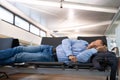 Man Sleeping In Airport Terminal Royalty Free Stock Photo