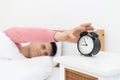 Man sleeping in bed early wake up not getting enough sleep Royalty Free Stock Photo
